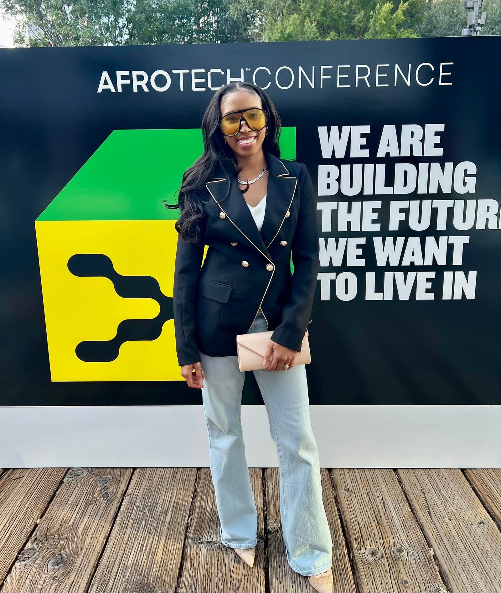 Black woman standing in front of AfroTech Conference sign