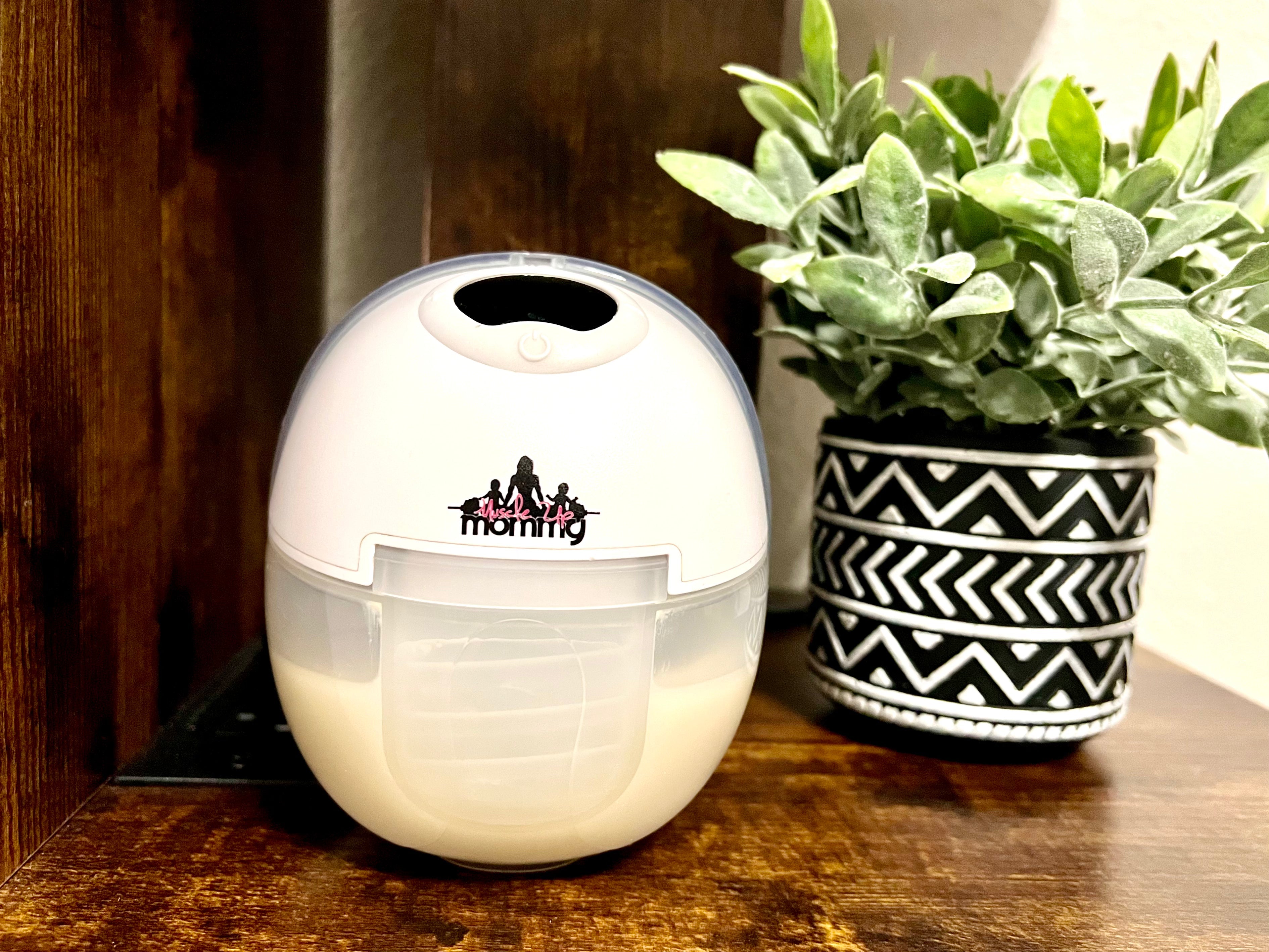 Breast pump sitting on desk in front of plant